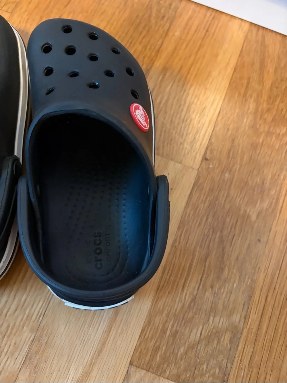Kid’s black Croc slip on shoe with white band size 8